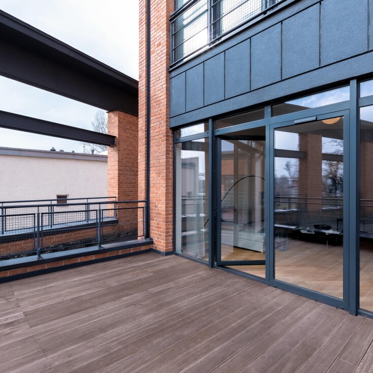 Modern apartment outside balcony bifold glass doors black frame