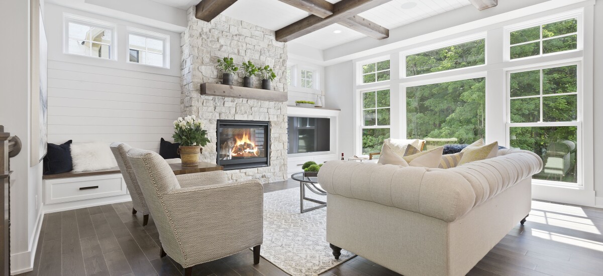 lounge room with white framed widows and wood flooring