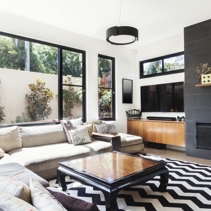 Modern apartment living room bifold glass doors black frame